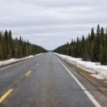 Thompson-Area Highways Report Mostly Bare Conditions with One Segment Partly Snow Packed as of April 1 - AI Generated Image
